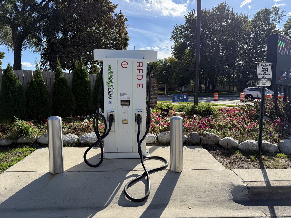 Two stainless steel bollard covers protecting an EV charging station at Fishbones restaurant in St. Clair Shores, Michigan