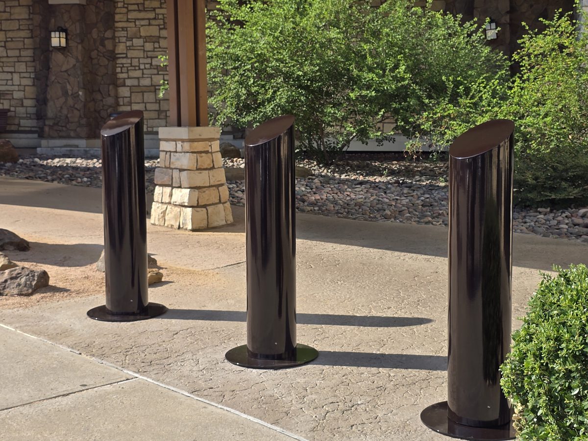 Three dark bronze powder coated 304 stainless steel slope-top bollards at the entrance of the Gaylord Texan Resort and Convention Center