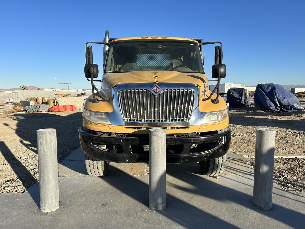 Medium-duty truck staged at the bollards before an ASTM M30 crash test