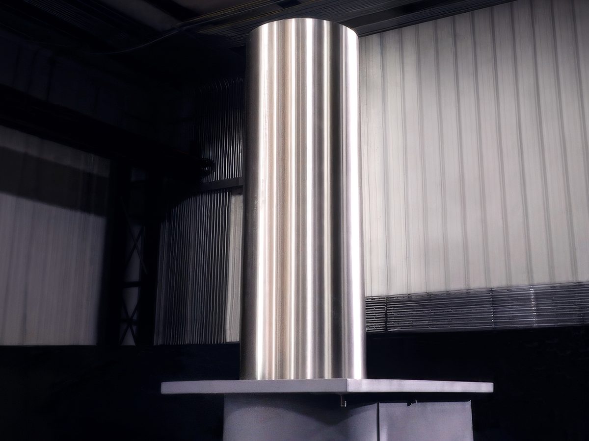 Brushed stainless steel hydraulic retractable bollard in the raised position at the fabrication shop