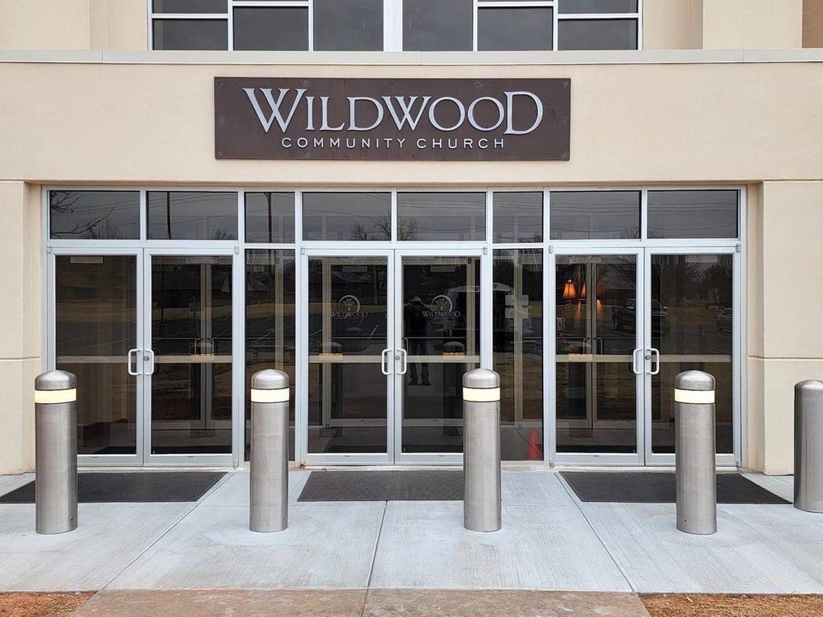 Brushed stainless steel dome-top bollard covers with reflective reveal bands at the Wildwood Community Church entrance